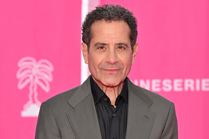 Tony Shalhoub stands in front of a pink backdrop for photo during the 6th Canneseries International Festival