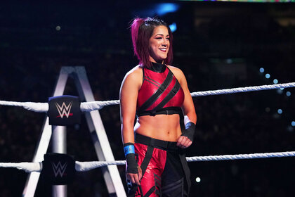 Bayley smiling as she stands in the ring