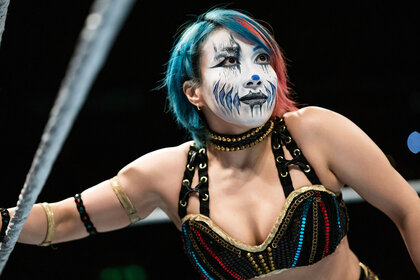 Asuka looks on while in the ring