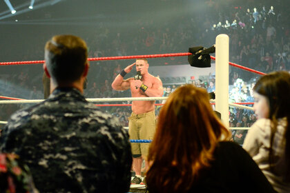 John Cena salutes the troops while standing in the ring