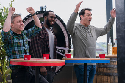 Chris Hardwick and Rob Riggle celebrate during a Barmageddon game