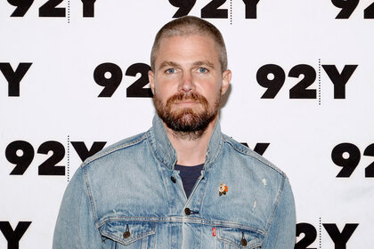 Stephen Amell wears a denim jacket during the 92nd y event for heels