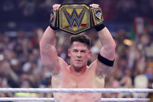 John Cena holding up a belt after defeating his opponent Cody Rhodes during WrestleMania 41.
