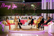 Love Island's Final four couples sitting on a couch with host Sarah Hyland.