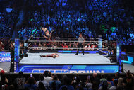 Wide view of the SmackDown ring as a fight takes place inside of it