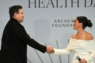 Carson Daly and Meghan, Duchess of Sussex shake hands onstage