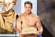 John Cena wears a golden toga onstage at the 96th Annual Oscars