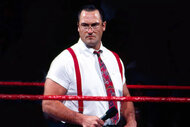 Mike Rotunda stands in the ring as 'IRS'.