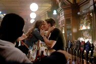 The Rainmaker's Sarah and Rudy kiss over a bar