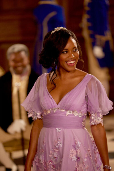 Nicole Remy wearing a lilac purple dress and smiling