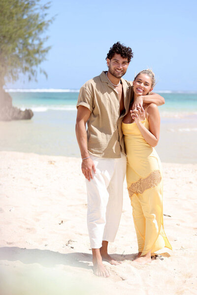 Kenzo Nudo and Carmen Kocourek on a beach embracing.