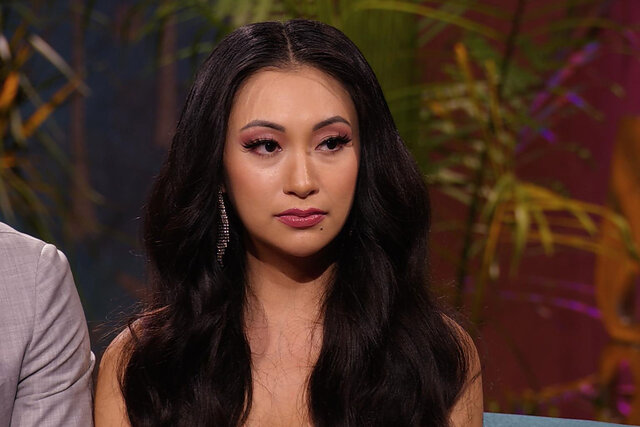 Close up of Iris at the reunion looking a little sad