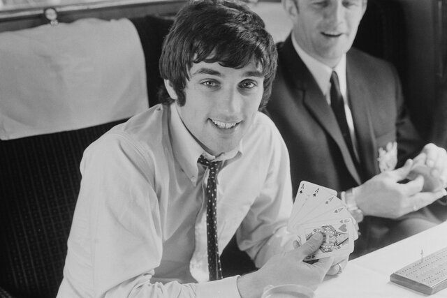 George Best playing cards on a train