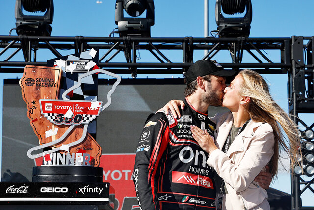 Daniel Suarez nd Julia Piquet kiss in victory lane after winning the NASCAR Cup Series Toyota