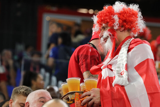A Denmark fan carries beer to his seat prior to the FIFA World Cup Qatar 2022 Group D match between France and Denmark