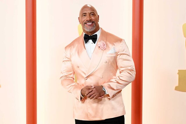 Dwayne Johnson smiles on the red carpet for the 95th Annual Academy Awards