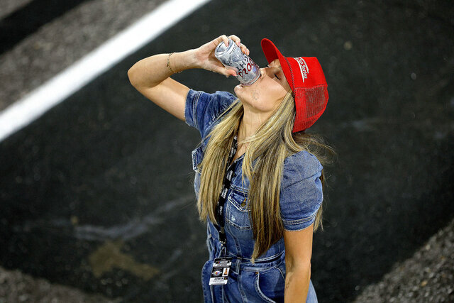 Katelyn Larson celebrates her husband, Kyle's All-Star win by chugging a beer