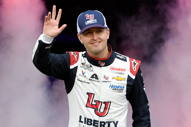 William Byron waves to the crowd at a race