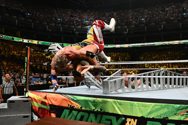 Logan Paul and Ricochet dive into a table during their Money In The Bank  match