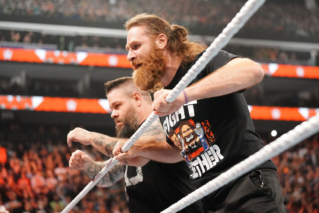 Sami Zayn and Kevin Owens lean on the top rope together