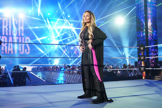 Trish Stratus stands in the ring looking out at the WWE crowd