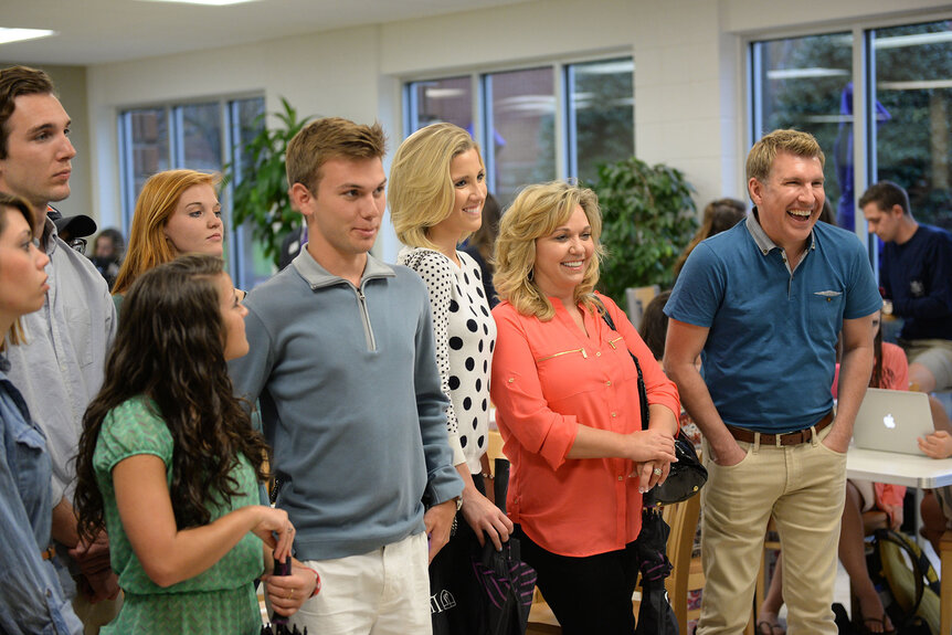 The entire Chrisley family looking off camera and smiling