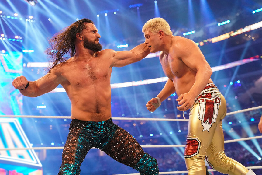 Seth Rollins punching Cody Rhodes in the ring
