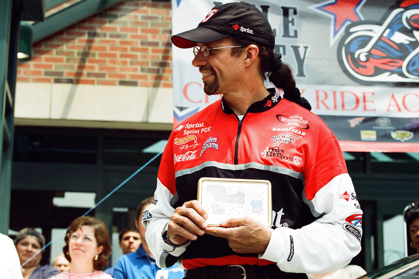 Nascar Driver Kyle Petty sporting a long ponytail under his cap