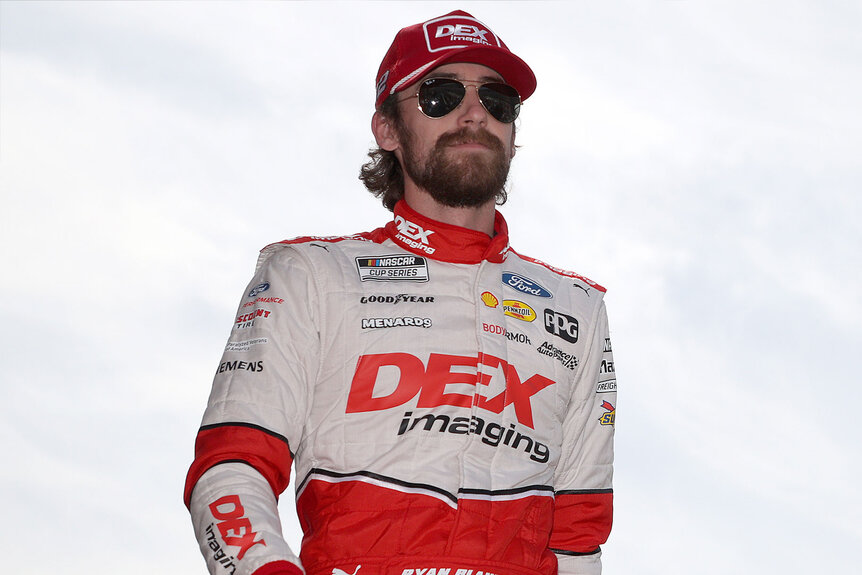 Nascar Driver Ryan Blaney sporting long hair and a mustache
