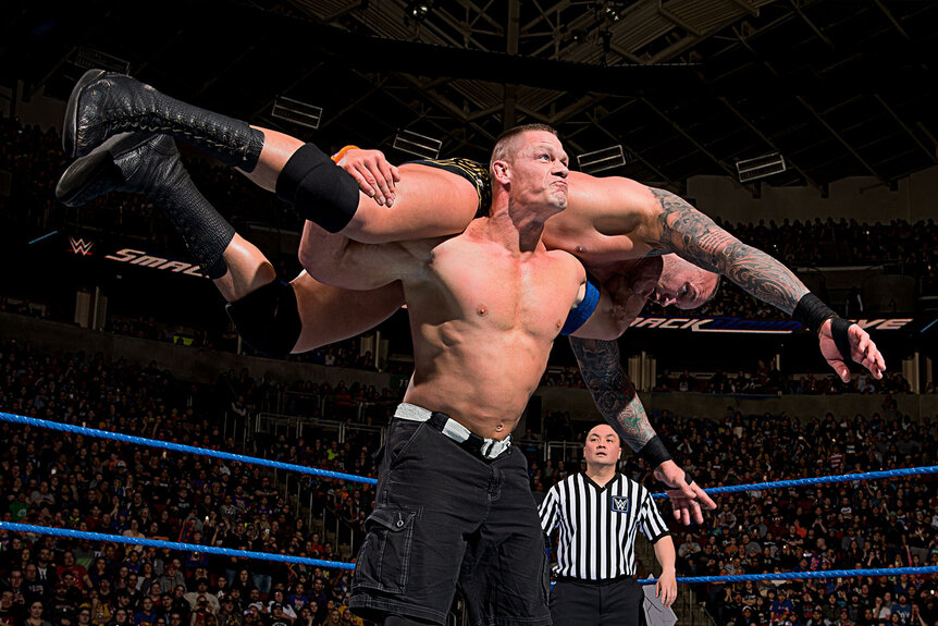 John Cena performing his signature move, "Attitude Adjustment" on another wrestler