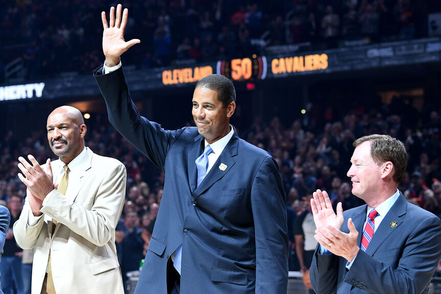 Former Cavaliers greats Larry Nance, Brad Daugherty, center, and Mark Price, left, wave to the crowd during a celebration for the Cavaliers 50th anniversary