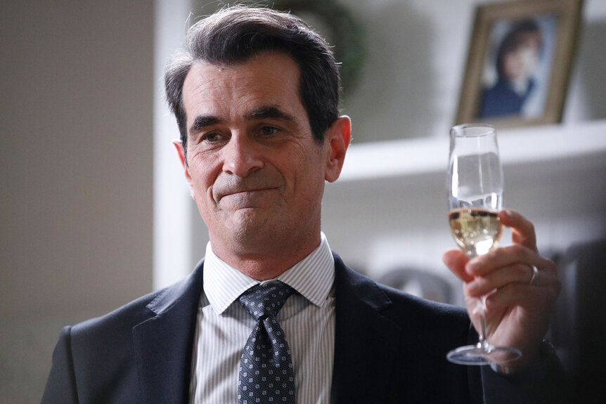 Ty Burrell holding a glass of champagne