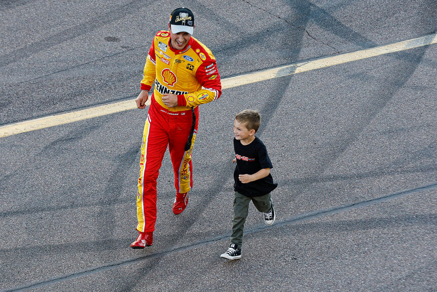 Joey Logano running with his son