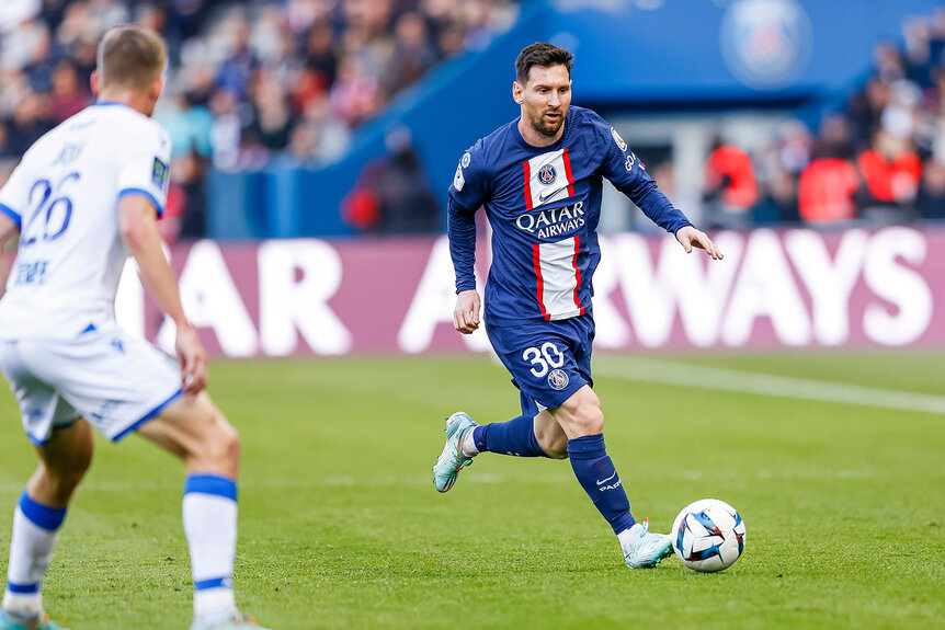 Lionel Messi of Paris Saint Germain runs with the ball during the Ligue 1 match between Paris Saint-Germain and AJ Auxerre