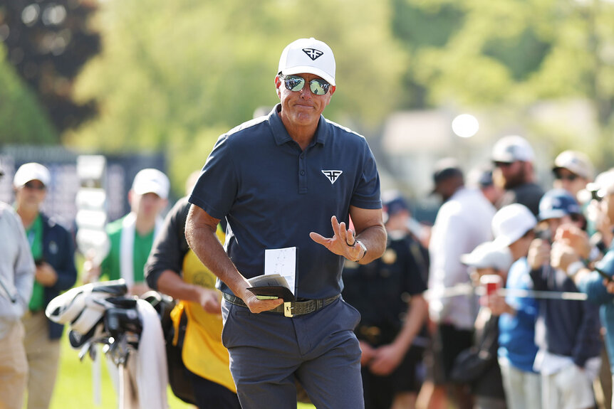 Phil Mickelson of the United States waves as he walks to the eighth tee during the final round of the 2023 PGA Championship