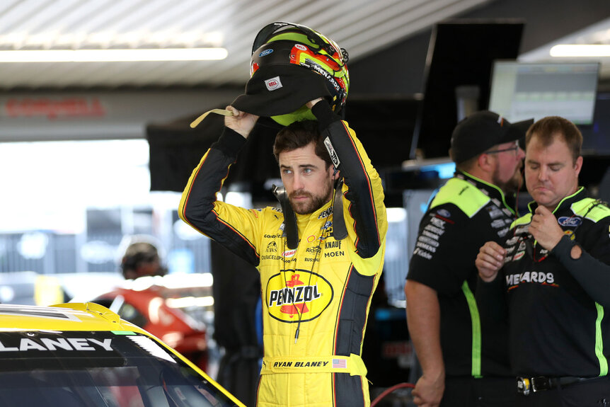 Ryan Blaney putting on his helmet