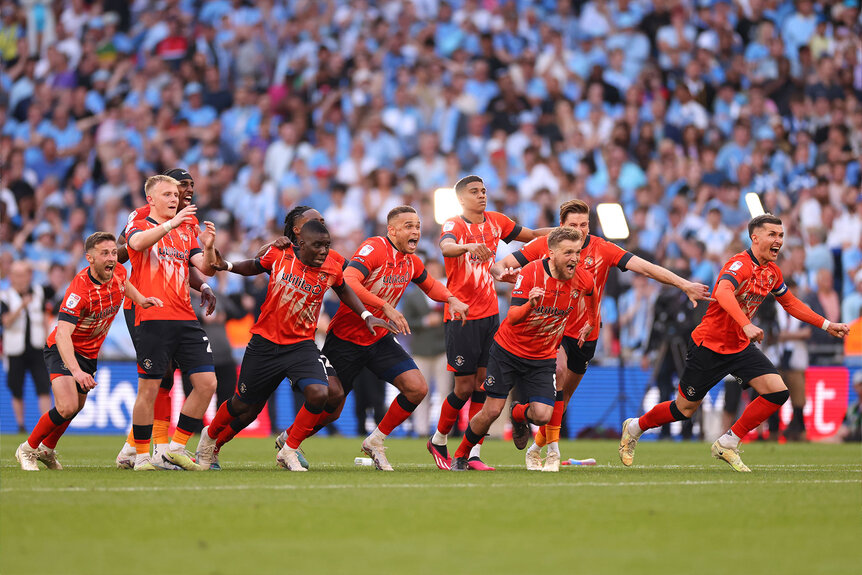 Luton Town players running onto the field