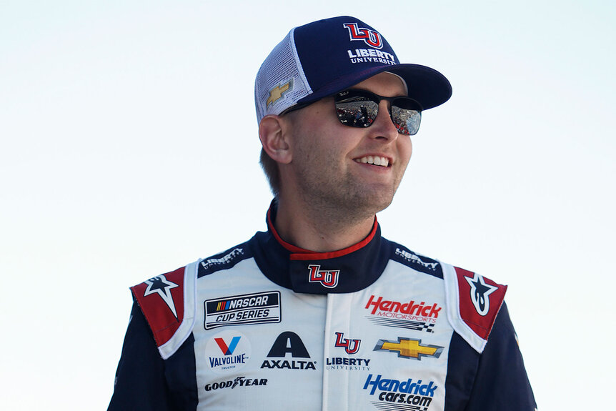 William Byron smiles while at a race
