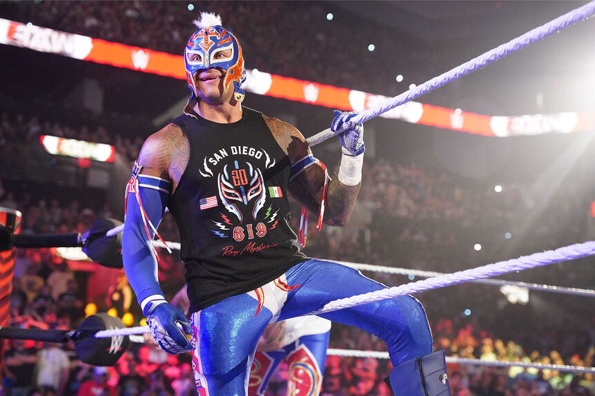 Rey Mysterio leans on the rope of the ring