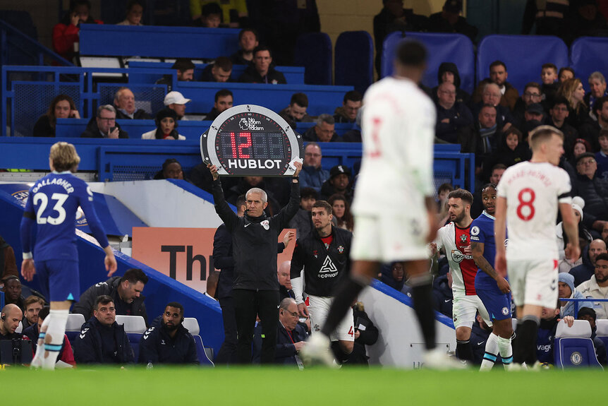 View of the Fourth Official lifting the HUBLOT board above his head