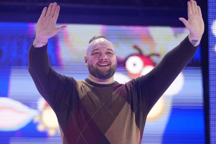 Bray Wyatt waves to the crowd during a WWE event.