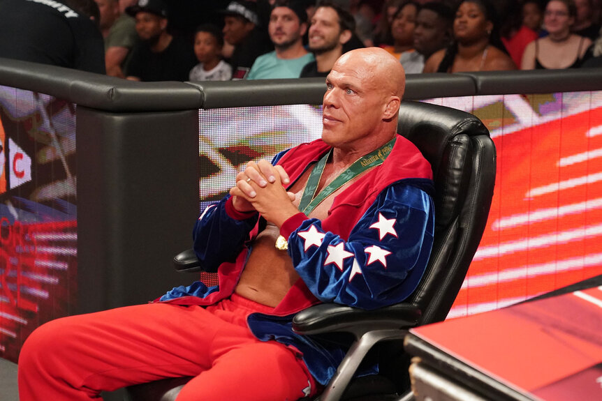 Kurt Angle looks on from the sidelines as the Street Profits wrestle in the ring