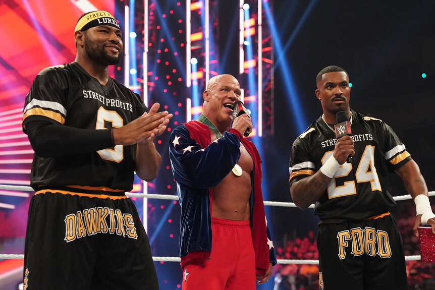 Kurt Angle and the Street Profits speak to the WWE crowd while standing in the ring