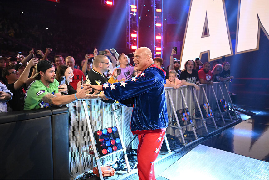 Kurt Angle greets fans in the audience during a wrestling event