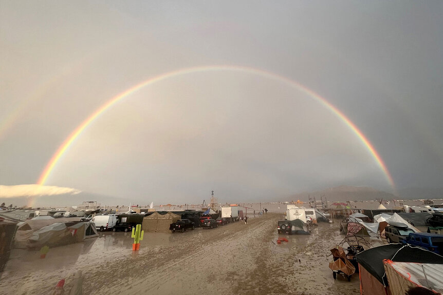 A rainbow seen over the muddy grounds of the "Burning Man" festival.