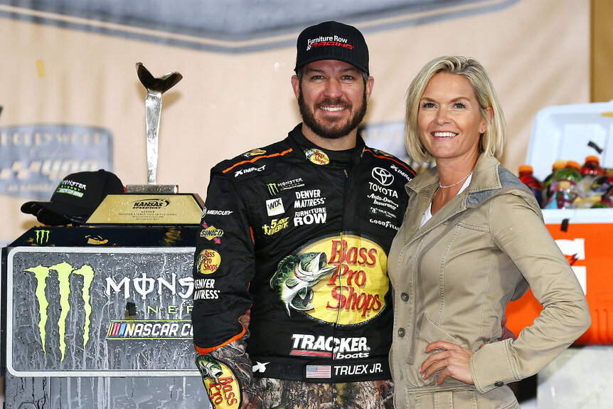 Martin Truex Jr. and Sherry Pollex, pose for a photo with the trophy in Victory Lane