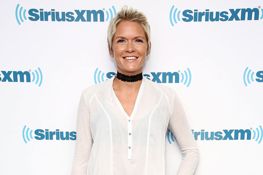 Sherry Pollex poses in front of a SiriusXM step and repeat