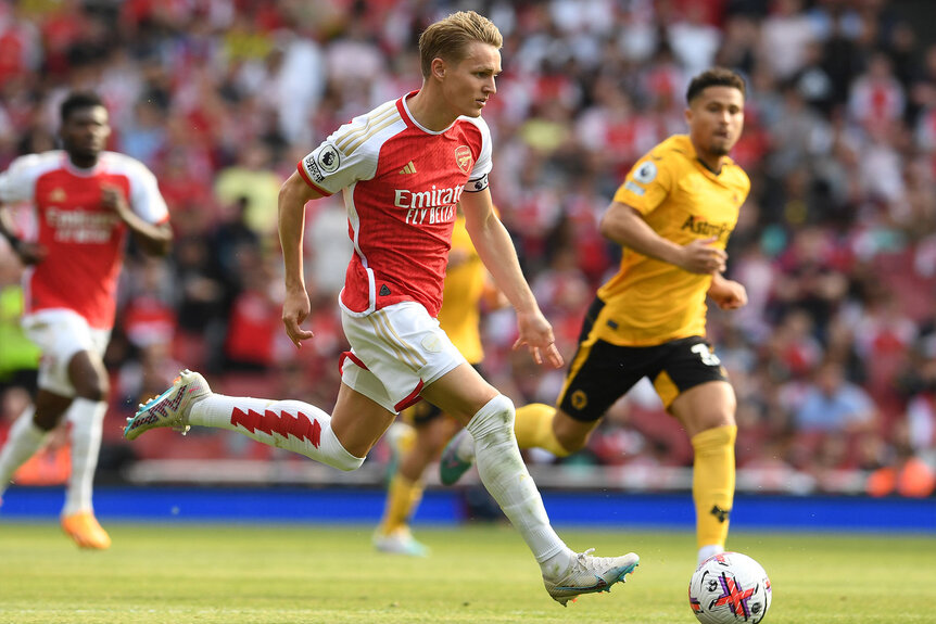 Martin Odegaard of Arsenal moves the ball down the field