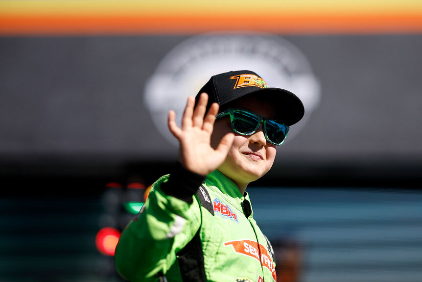 Brexton Busch, the son of NASCAR Cup Series driver, Kyle Busch, waves to fans