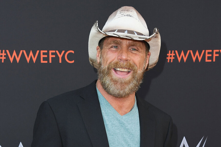 Shawn Michaels smiles on the red carpet of a WWE event